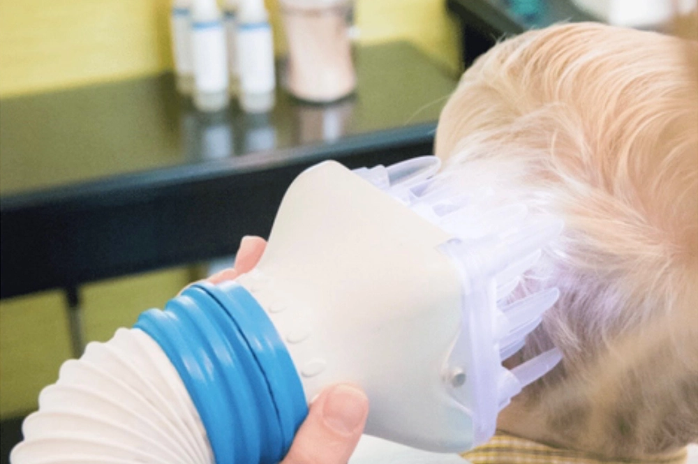 Child relaxing during Flosonix heated air treatment